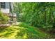 Spacious backyard features a wooden deck, lush greenery, and mature trees in a private setting at 1294 Red Rock Rd, Acworth, GA 30101