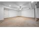 A large, carpeted unfinished basement with two white doors and a ceiling fan at 1294 Red Rock Rd, Acworth, GA 30101