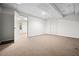 An unfinished basement with carpeted flooring and two entryways at 1294 Red Rock Rd, Acworth, GA 30101