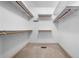 Well-organized walk-in closet with multiple shelves and hanging rods for optimal storage solutions at 1294 Red Rock Rd, Acworth, GA 30101
