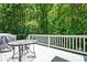 Wooden deck features a dining table and chairs among lush green trees, perfect for entertaining at 1294 Red Rock Rd, Acworth, GA 30101
