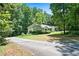 Secluded one-story house surrounded by abundant trees and greenery, accessed by a paved driveway at 1294 Red Rock Rd, Acworth, GA 30101