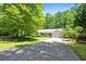 One-story home with a covered front porch and attached two-car garage surrounded by lush greenery at 1294 Red Rock Rd, Acworth, GA 30101