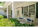 Inviting front porch with rocking chairs, plants, and decorative columns, creating a welcoming entrance at 1294 Red Rock Rd, Acworth, GA 30101