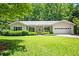 Charming one-story home with a well-maintained lawn, covered front porch, and attached two-car garage at 1294 Red Rock Rd, Acworth, GA 30101
