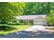 Quaint single-story home with a covered front porch, attached garage, and an expanse of green lawn at 1294 Red Rock Rd, Acworth, GA 30101