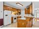 Well-lit kitchen featuring wooden cabinets, white appliances, and a breakfast bar at 1294 Red Rock Rd, Acworth, GA 30101