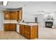 Kitchen featuring wooden cabinets, white appliances, and a breakfast bar open to the living room at 1294 Red Rock Rd, Acworth, GA 30101