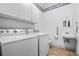 Laundry room with modern washer and dryer, sink, and updated fixtures for efficient cleaning at 1294 Red Rock Rd, Acworth, GA 30101