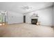 Spacious carpeted living room showcasing a fireplace, neutral walls, and large area for entertaining at 1294 Red Rock Rd, Acworth, GA 30101