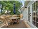 Back deck featuring wood-style patio furniture and an umbrella, as well as trees at 2316 Hurst Ne Dr, Atlanta, GA 30305