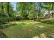Grassy backyard with scattered trees and sunlight visible at 2316 Hurst Ne Dr, Atlanta, GA 30305