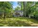 Landscaped backyard view featuring a deck, mature trees, and a well-maintained lawn at 2316 Hurst Ne Dr, Atlanta, GA 30305