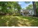 Expansive backyard featuring a charming deck, lush lawn, and mature trees offering ample shade at 2316 Hurst Ne Dr, Atlanta, GA 30305