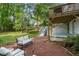Charming backyard patio with seating area, lush greenery, and a deck above, perfect for relaxation at 2316 Hurst Ne Dr, Atlanta, GA 30305