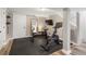 Basement gym featuring rubber flooring, a peloton bike, a mirror, and access to the stairs at 2316 Hurst Ne Dr, Atlanta, GA 30305