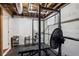 Basement features ceiling pipes, painted walls, and workout equipment at 2316 Hurst Ne Dr, Atlanta, GA 30305