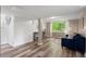 Basement with vinyl floors, a window, shiplap, a desk, and a blue sofa at 2316 Hurst Ne Dr, Atlanta, GA 30305