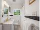 Bathroom featuring black and white tiles, a sink, a mirror, and a shower with a white curtain at 2316 Hurst Ne Dr, Atlanta, GA 30305