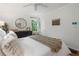 Bright bedroom featuring a round mirror, windows with green views, and a plush blanket on the bed at 2316 Hurst Ne Dr, Atlanta, GA 30305