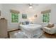 Bright bedroom featuring two windows with green views, a chair and hardwood floors at 2316 Hurst Ne Dr, Atlanta, GA 30305