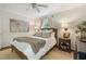 Bright bedroom featuring a ceiling fan, windows with green views, and bedside tables with lamps at 2316 Hurst Ne Dr, Atlanta, GA 30305
