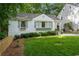Charming white home featuring a manicured front yard, grey shutters and window boxes at 2316 Hurst Ne Dr, Atlanta, GA 30305