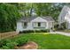 Charming white home featuring a manicured front yard, grey shutters and window boxes at 2316 Hurst Ne Dr, Atlanta, GA 30305