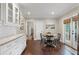 Eat-in kitchen with white cabinetry, hardwood flooring, and access to the backyard at 2316 Hurst Ne Dr, Atlanta, GA 30305