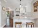 Bright kitchen with stainless steel appliances, white cabinetry, barstool seating and hardwood flooring at 2316 Hurst Ne Dr, Atlanta, GA 30305