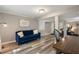 Living room features a comfortable blue sofa and luxury vinyl plank flooring, as well as fitness equipment at 2316 Hurst Ne Dr, Atlanta, GA 30305