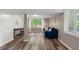 Bright living room features wood-look floors, a shiplap accent wall, and a comfortable blue couch at 2316 Hurst Ne Dr, Atlanta, GA 30305