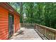 Exterior of home featuring wooden back deck with a view of the woods at 2420 Leaf Land Dr, Duluth, GA 30097