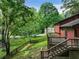 Charming home backyard with a wooden fence and mature trees at 2420 Leaf Land Dr, Duluth, GA 30097