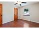 Bedroom features wood floors, a ceiling fan, natural light, and a classic wooden door at 2420 Leaf Land Dr, Duluth, GA 30097