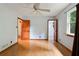 Bright bedroom with laminate floors, a modern ceiling fan, natural light, and a classic wooden door at 2420 Leaf Land Dr, Duluth, GA 30097
