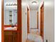 Hallway with a bathroom and multiple doors for entering bedrooms and closets at 2420 Leaf Land Dr, Duluth, GA 30097
