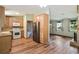Open concept kitchen with wood cabinets, stainless steel fridge and spacious eat-in area at 2420 Leaf Land Dr, Duluth, GA 30097
