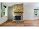 Bright living room showcasing a stone fireplace, wood floors, and natural light at 2420 Leaf Land Dr, Duluth, GA 30097