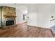 Spacious living room featuring a stone fireplace and wood-style flooring at 2420 Leaf Land Dr, Duluth, GA 30097
