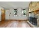Bright living room with a stone fireplace, hardwood floors and entrance to the front door at 2420 Leaf Land Dr, Duluth, GA 30097
