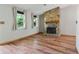 Cozy living room showcasing a stone fireplace, wood flooring and natural light at 2420 Leaf Land Dr, Duluth, GA 30097