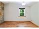 Living room featuring a stone fireplace, hardwood floors, and natural light at 2420 Leaf Land Dr, Duluth, GA 30097