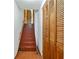 Hallway featuring stairs and natural wood paneled closets at 2420 Leaf Land Dr, Duluth, GA 30097