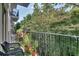 Relaxing balcony view of the lush trees, greenery, and a patio set with padded seating at 3203 Lenox Ne Rd # 22, Atlanta, GA 30324