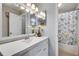 Bright bathroom features a large vanity, a decorative butterfly shower curtain, and a neutral color palette at 3203 Lenox Ne Rd # 22, Atlanta, GA 30324