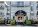 Elegant condo building entrance with black awning and landscaped shrubbery at 3203 Lenox Ne Rd # 22, Atlanta, GA 30324