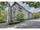 Multi-story condo building exterior view showcasing balconies and mature trees at 3203 Lenox Ne Rd # 22, Atlanta, GA 30324