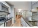 Open kitchen view with granite counters, stainless appliances, and view of the dining room at 3203 Lenox Ne Rd # 22, Atlanta, GA 30324