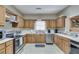 Traditional eat-in kitchen featuring oak cabinets, white countertops, and stainless steel appliances at 3203 Lenox Ne Rd # 22, Atlanta, GA 30324